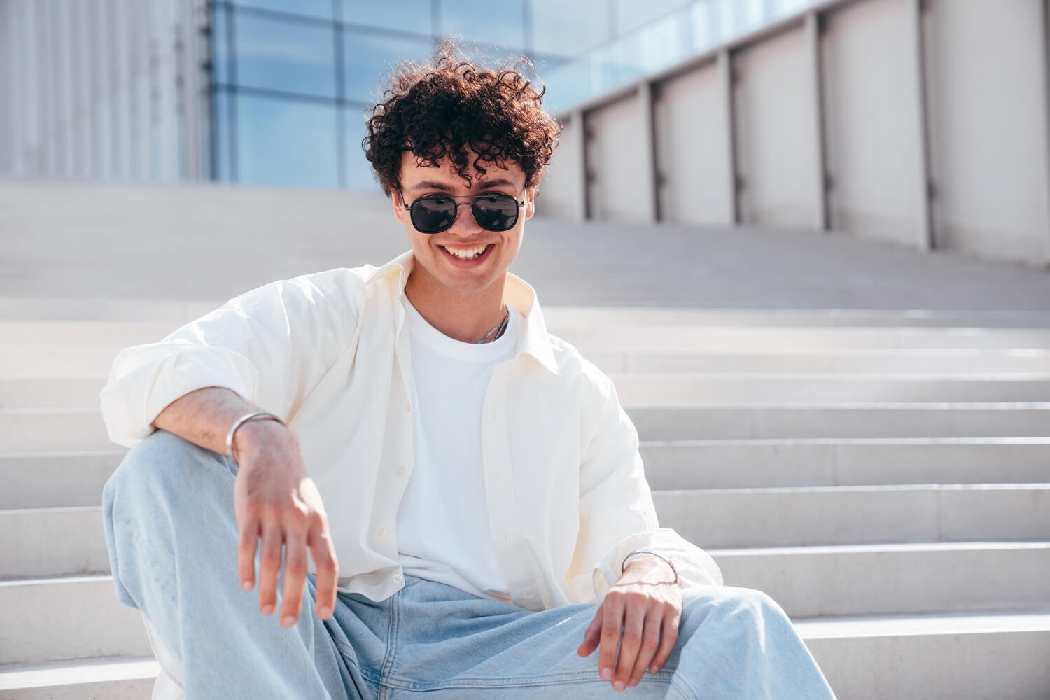 young-attractive-man-sits-at-stairs-9DH3EPJ.jpg